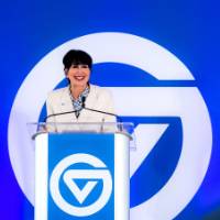 President Philomena Mantella standing at podium and smiling at audience